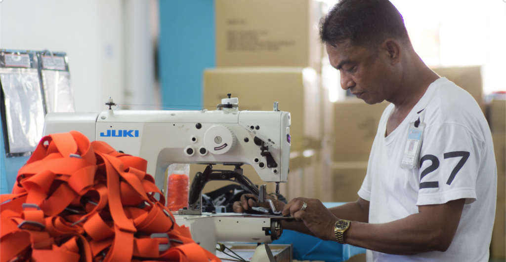 Photo of man working at a sewing machine